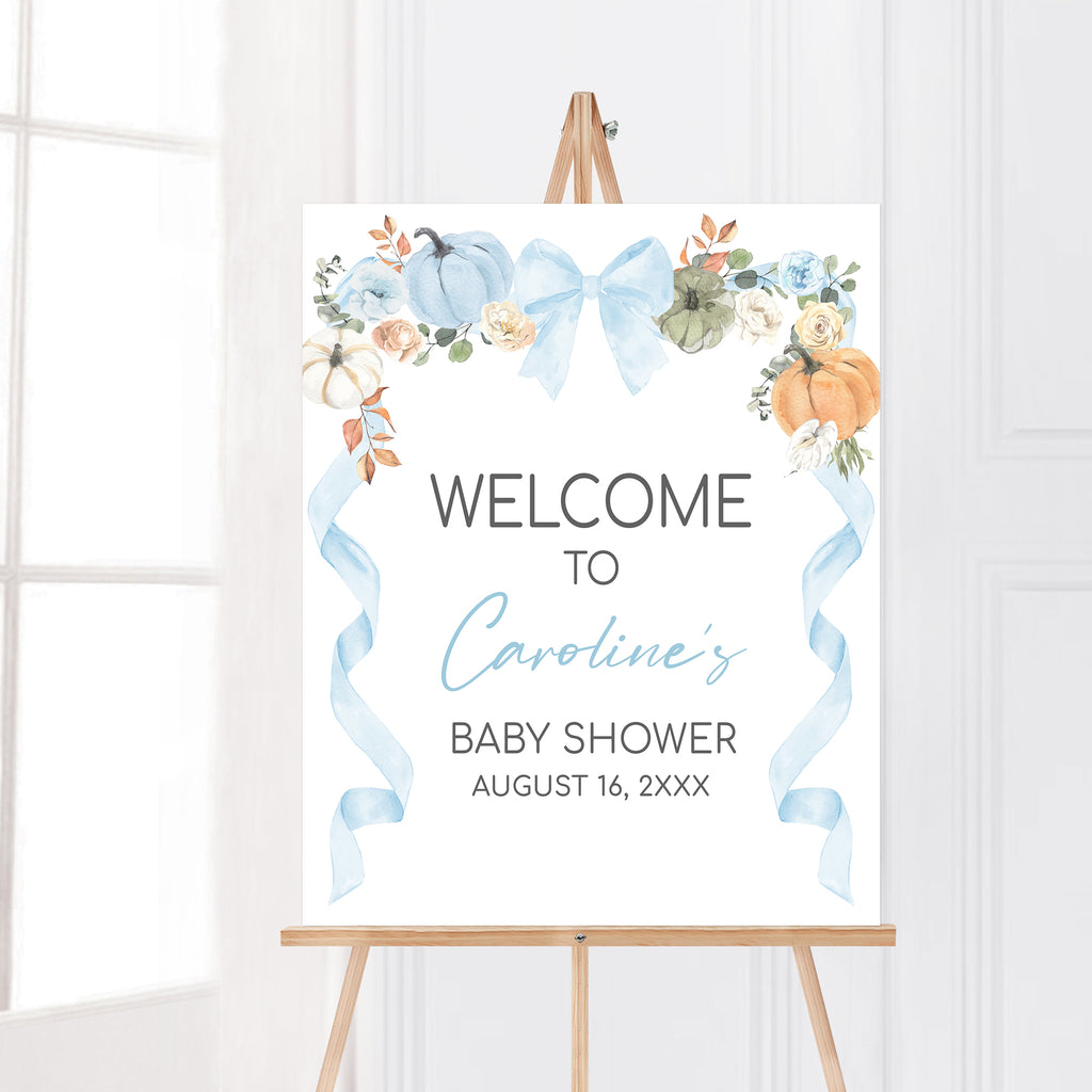 Rustic fall baby shower welcome sign with watercolor pumpkins and blue bow for a little pumpkin themed event