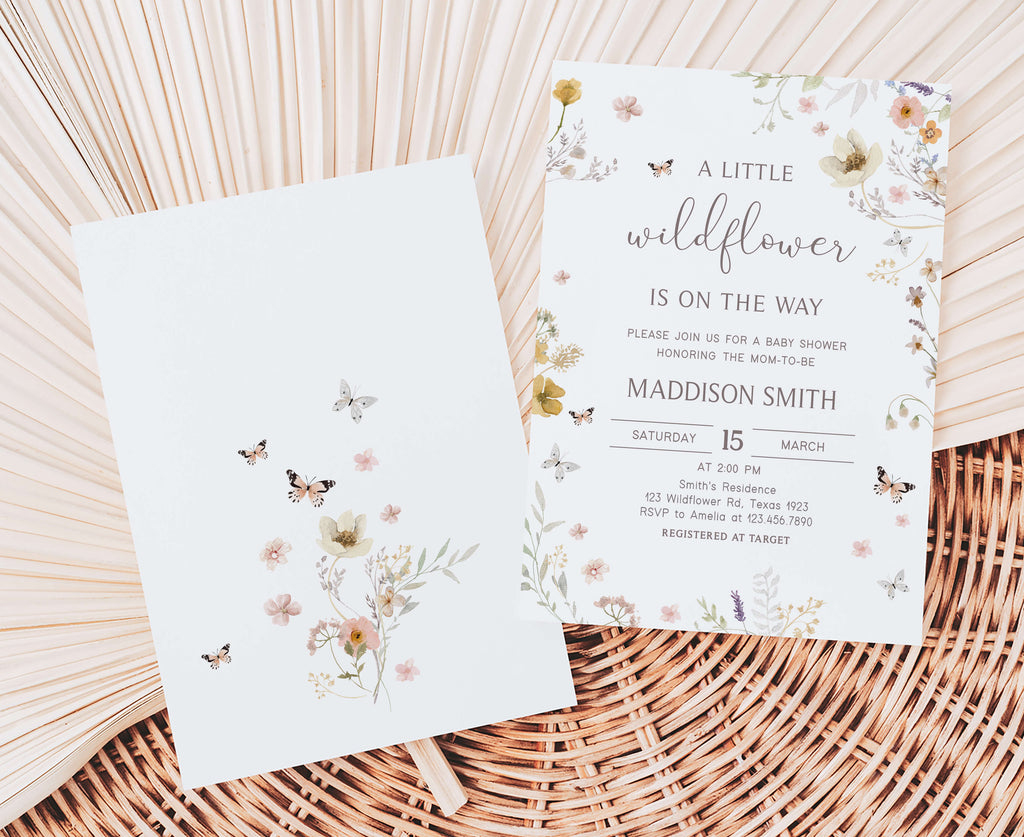 Floral baby shower invitation on a woven surface