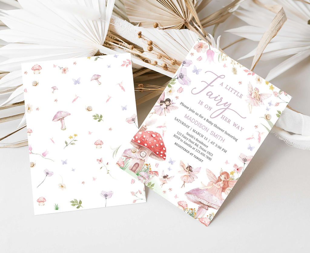 Fairy-themed baby shower invitations on a decorative background with dried plants.