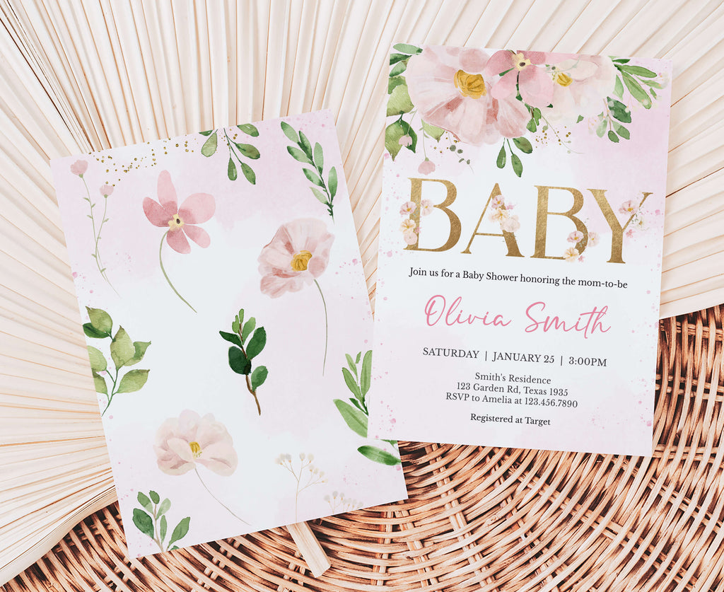 Two baby shower invitations with floral designs on a woven surface