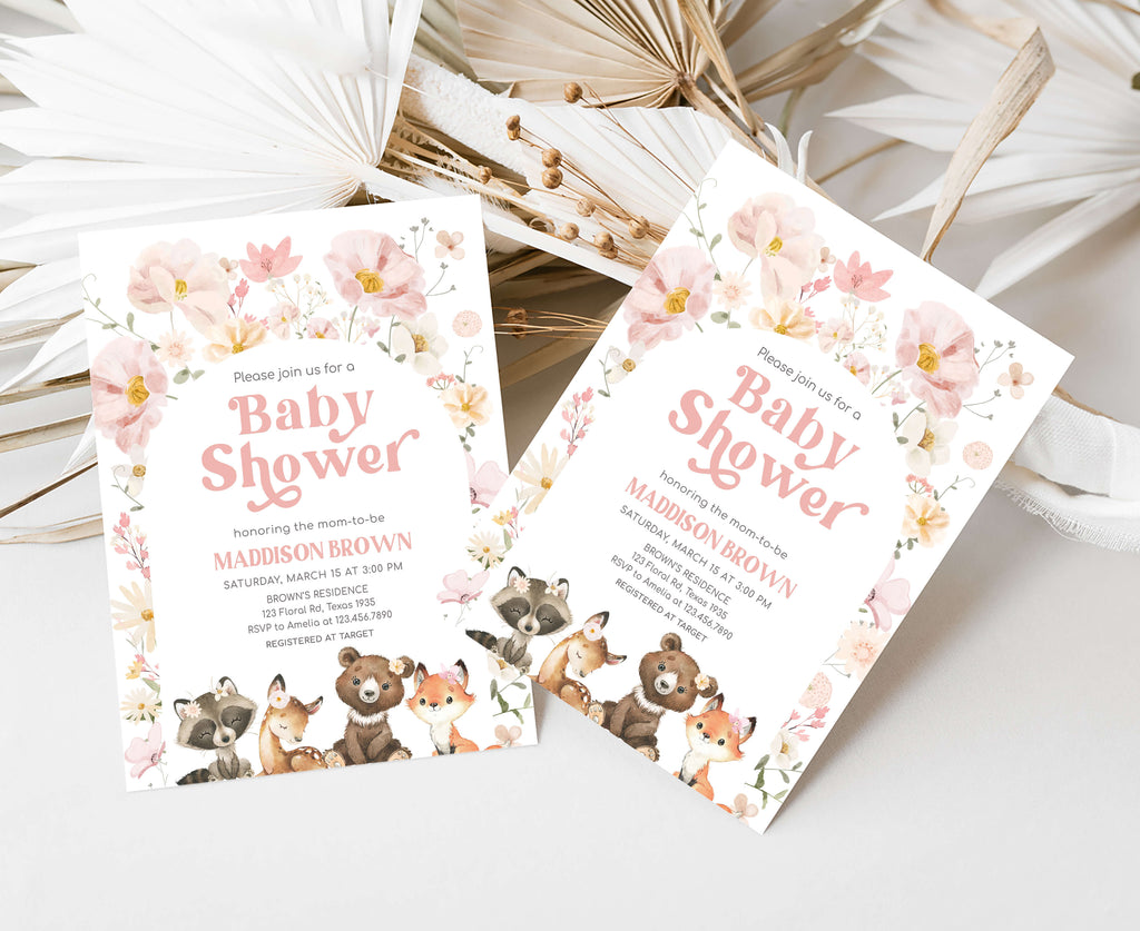 Two baby shower invitations with floral designs and animal illustrations on a white surface.