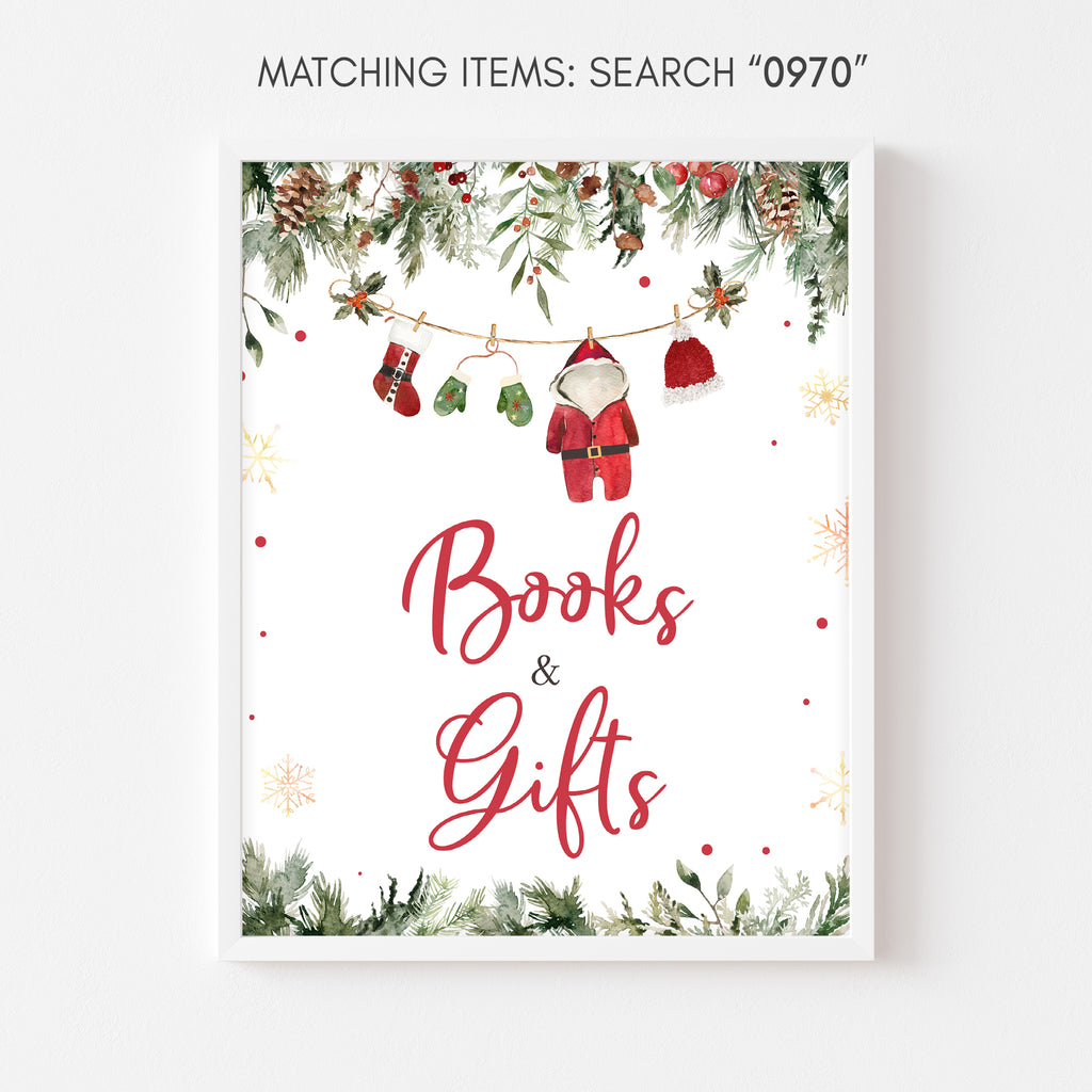 Holiday baby shower books and gifts sign with Santa baby theme and winter greenery accents