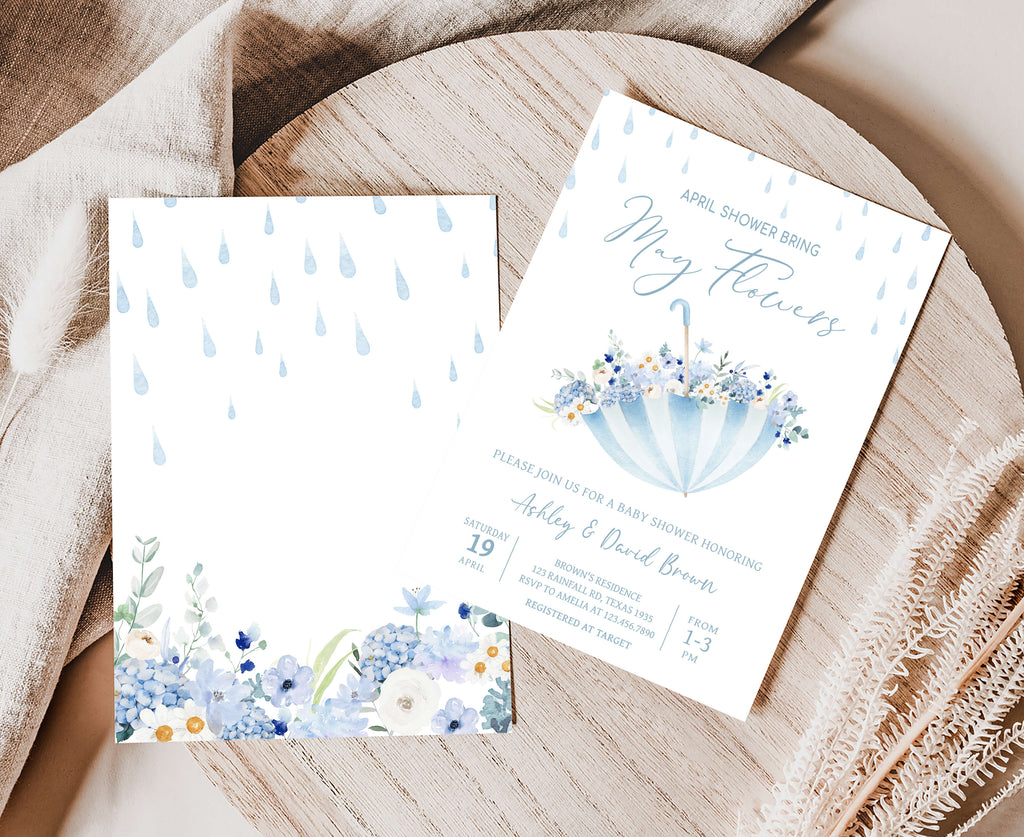 Floral-themed baby shower invitation on a wooden surface