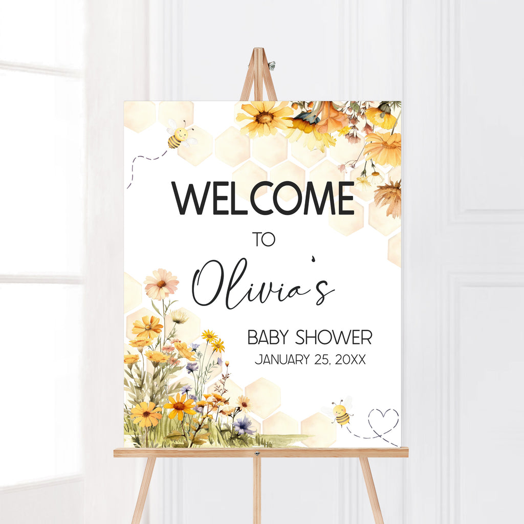 Honey bee baby shower welcome sign with spring floral and honeycomb accents for gender neutral little honey theme