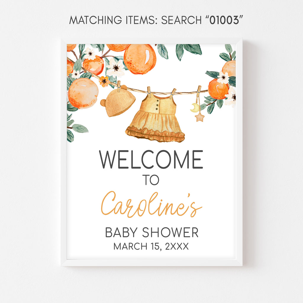 Baby shower invitation with baby clothes and oranges on a white background