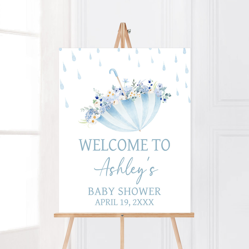 Spring baby shower welcome sign with umbrella and floral may flowers theme for gender neutral event