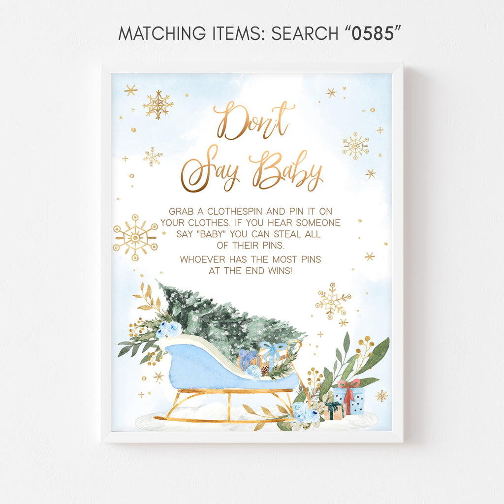 Winter wonderland don’t say baby game sign boy with gold snowflakes and greenery