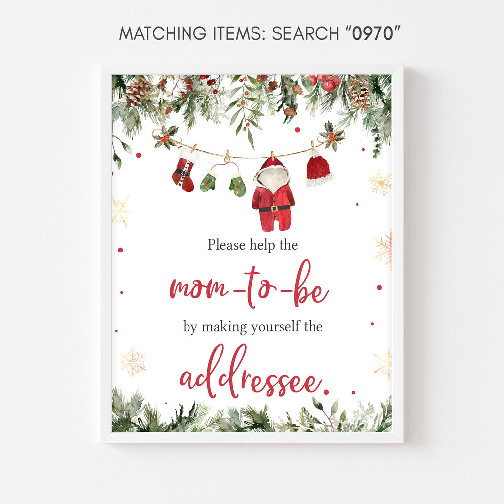 Santa baby shower envelope station sign with Christmas greenery and holiday accents