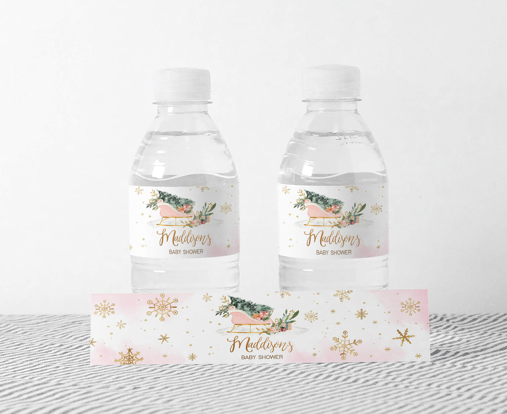 Pink winter baby shower bottle labels with snowflakes and festive girl design