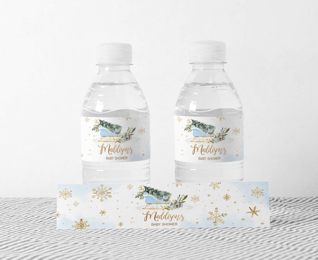 Winter baby shower bottle labels boy with blue sleigh, snowflakes, and greenery design